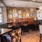 The interior restaurant seating area with electronic pub game at The Spread Eagle.