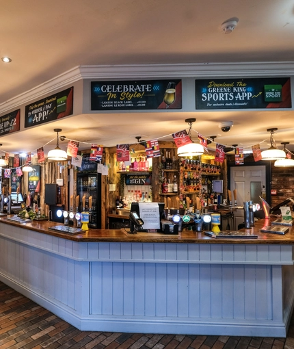 Interior dining area of a pub with a bar.