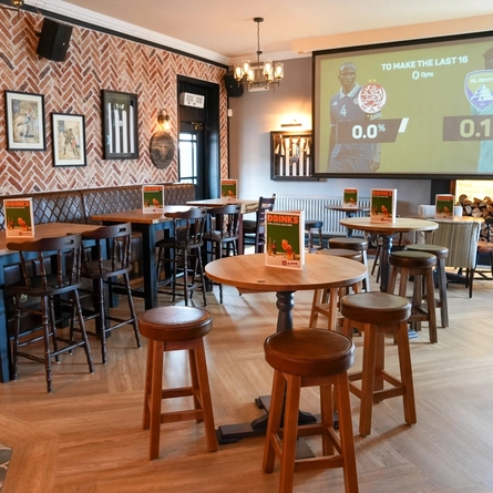 The interior restaurant seating area with TV at The Peregrine.