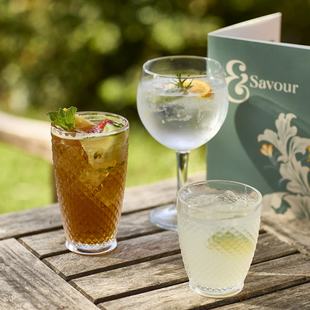 An exterior shot of summer drinks being served for the Summer Drinks Promo at Chef & Brewer venues.