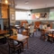 The interior restaurant seating area at the Devonshire Arms in Sheffield, with booth seating, a fireplace, and a TV on the wall above it.