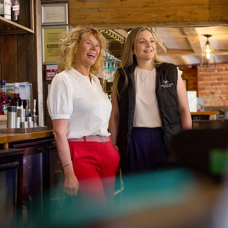 A Pub Partners image showing 2 people stood behind the bar within the Shinfield Arms.