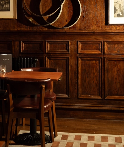 An image of the interior Snug seating area with wood panelling at The Ubiquitous Chip.