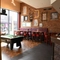 Interior bar and dining area of a pub with a pool table.