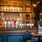 The bar and interior restaurant seating area at The Tamar, with upholstered bar stool seating, and a TV on the wall in the background.