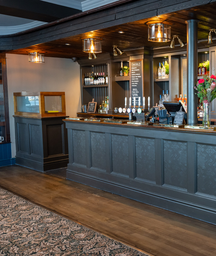 The interior bar with embossed panelling and wooden flooring at The Spice Island.