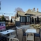 Exterior beer garden with wooden picnic benches