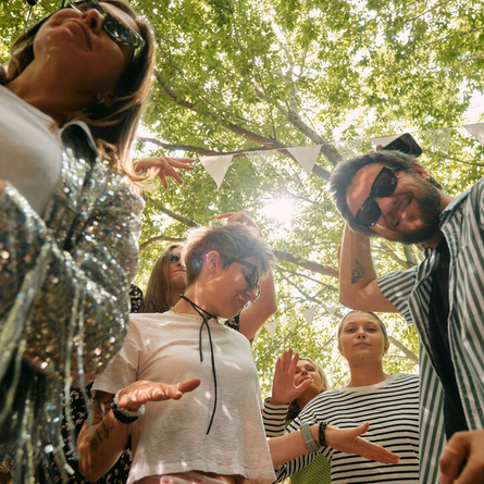 An image showing a group of people dancing and having fun to advertise Summer Parties at Chef & Brewer venues.