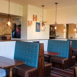 The interior restaurant seating area booths with TV at The Wolds.