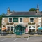 The exterior facade and beer garden seating area at The Hare & Hounds.
