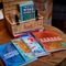 A table set up with puzzle books and a games hamper