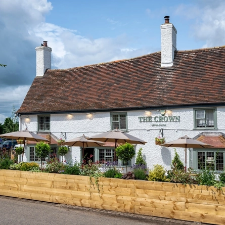 The exterior facade with seating area at the Crown Inn.