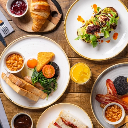 Various plated Brunch Dishes including a Full English, Vegetarian Full English, Bacon Sandwich, Sausage Sandwich, Smoked Salmon, Avocado On Toast and Croissant with jam at Crafted venues.