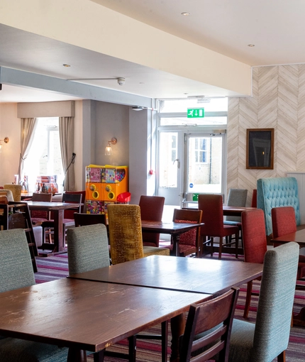 Interior dining area of a pub with a few toy vending machines.