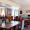 Interior dining area of a pub with a few toy vending machines.