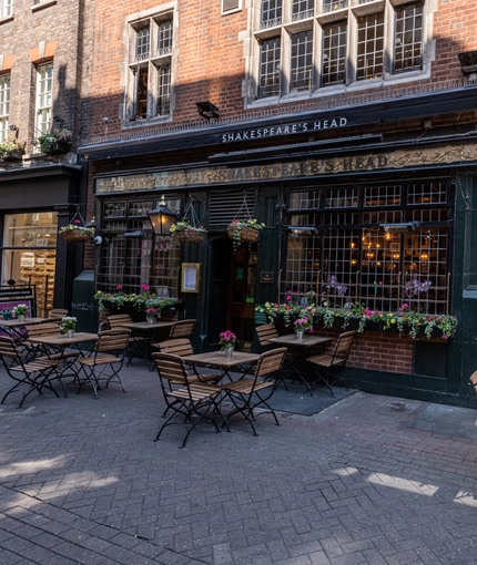 External view of a pub entrance and beer garden