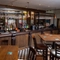 The bar and interior seating area at The Man On The Moon, with wooden tables and chairs.