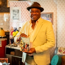 A historian 'Tony Fairweather' showing Greene King staff a staged Windrush Front Room during Black history month.