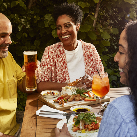 Guests enjoying food and drink in a Chef and Brewer beer garden