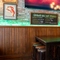 The bar and interior seating area of Molly Malones, with wooden furniture and TVs on the walls.