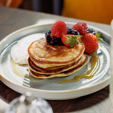 An advertising image of pancakes and fresh fruit available at Crafted Venues.