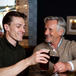 Two people holding glasses of wine