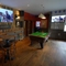 interior of the restaurant with seating area and pub games