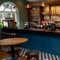A close up view of the bar inside the Clocktower in Milton Keynes, with tables and bar stools.