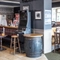 Interior dining area of a pub with a TV and a gambling machine.