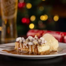 a cheesecake sitting on a wooden table of a pub