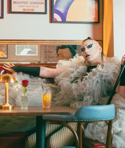 An image of one of the Drag Queens sat within the interior restaurant and seating area at The City Of Quebec.