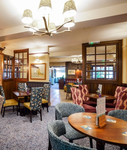 The interior restaurant seating area with feature fireplace at The Two Greens.
