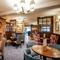 The interior restaurant seating area with feature fireplace at The Two Greens.