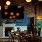 The interior restaurant seating area of The White Hart, with a TV on the wall, and a fireplace.