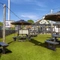 The exterior beer garden seating area with wooden tables and umbrellas, at The Good Intent in Hornchurch.