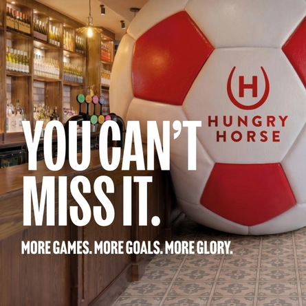 A banner promoting the new football season at Hungry Horse venues. The banner shows an interior of a Hungry Horse-branded sports bar featuring a giant football-shaped wall installation beside the bar. Large white text reads “YOU CAN’T MISS IT.” with smaller text underneath stating “MORE GAMES. MORE GOALS. MORE GLORY.” A television screen showing a football match is visible in the background above beer taps and shelves of bottles.