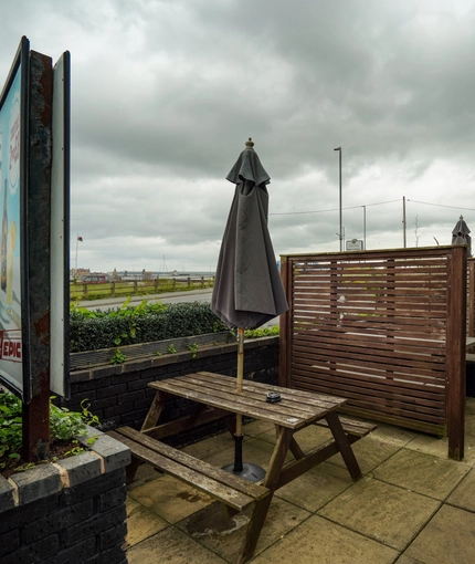 Exterior beer garden of a pub with a seating area.