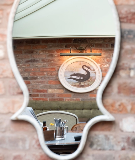 A reflection of a picture of a Dunk in a mirror inside the Dirty Duck.