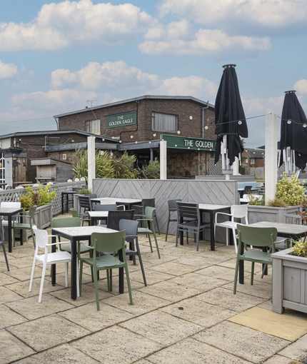 Exterior beer garden of a pub with a seating area.