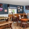 Interior dining area of a pub with a TV.