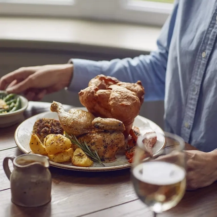 A chicken roast dinner on a table.