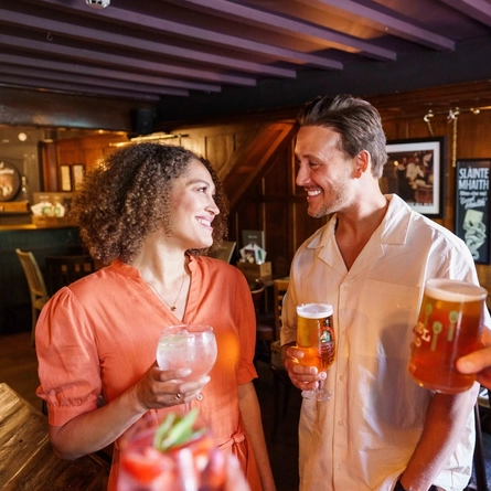 An interior image of people enjoying drinks during the Q3 Happy Hour Event.