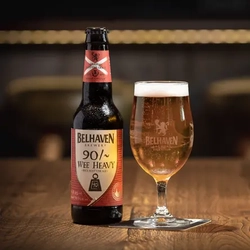 A bottle of Belhaven Wee Heavy, next to a pint of beer.