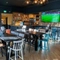 The bar and interior restaurant seating area of Whitehills in Northampton, with TVs on the walls.