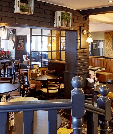 The interior restaurant seating area and decor at The Good Intent in Hornchurch.