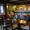 The interior restaurant seating area of the Smiths Arms pub, with wooden beams, upholstered booth seating, wooden tables, and framed artwork on the wall.