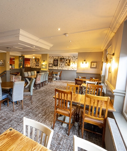 Interior dining area of a pub with a bar.