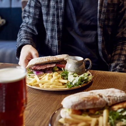 A man with a plate of food in front of him.