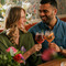 An image focusing on 2 customers enjoying Valentines Day Date Night cocktails and celebrating with a cheers sat at a table within the interior seating area at The Crown.