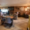 Interior dining area of a pub with a TV and a fireplace.